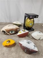 Assortment of Packer footballs