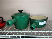 Two Le Creuset covered pots in forest green