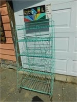 Vintage metal wire rack with a sign on top.