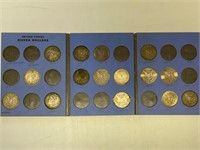 15 - Morgan silver dollars in book