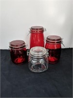 Group of red and clear canisters. 5.5", 7", and