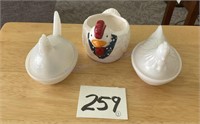Two glass chickens, and one ceramic chicken