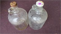 2 gallon jugs (glass) with lids. Rusty lids