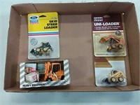 assortment of 1/64 scale skid loaders and forklift