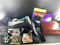 Dufflebag containing CDs, old film cameras, notebo