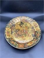 Ornate display platter with floral scene painted o