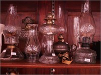 Five oil lamps, mostly glass bottoms, all