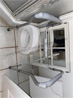 Appears to be mountable bath rail & potty seat,