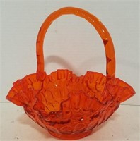 Orange colored art glass basket