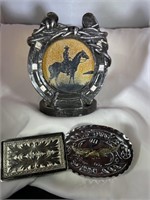 TWO BELT BUCKLES AND A HORSESHOE CANDLE  HOLDER