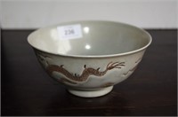 Cream glazed bowl decorated with a dragon among