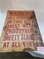 metal sign saying "safety glasses at all times"