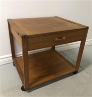 teak side table with drawer. On coasters