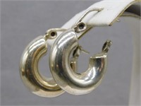 Sterling Silver pierced hoop earrings.