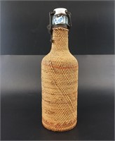 Antique glass bottle with hinged lid, has been com