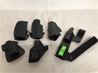 Six pistol holsters one leather five hard plastic