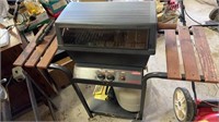 Sunbeam gas grill, with some charcoal inside,