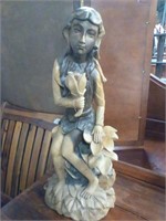 Wood carved statue of girl