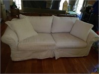 Upholstered Beige Couch and Two Throw Pillows