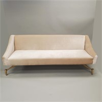Contemporary floating sofa on unique brass legs