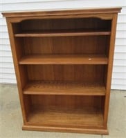 Wood bookshelf. Measures: 48" H x 36" W x 12" D.