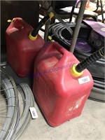 Pair of plastic 5-gallon gas cans