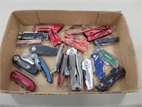 assortment of knives and multi tools
