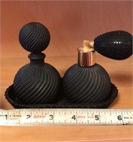 2 Nice black perfume bottles on tray.