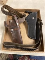 two holsters and ammunition belts