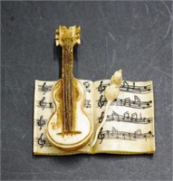 Vintage carved ivory violin, mouse and music