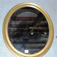 oval beveled glass mirror in gold frame 30x25"