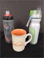 Two travel water bottles and a mug