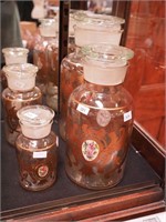 Four decorated apothecary jars with gold