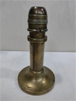 Weighted brass push-up candlestick used on