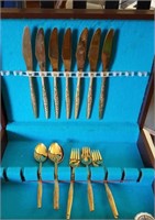 Gold look flatware in wood storage box,