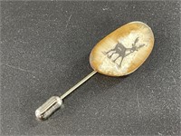 Fossilized ivory pin with detailed Alaskan scrimme