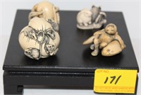 ONE BONE AND 4 PLASTICE ORIENTAL SMALL FIGURES