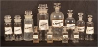 12 Antique Colorless Glass Apothecary Bottles.