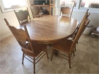 Large wooden oval shaped table with 6 chairs