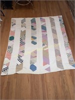 Hand stitched stripe patchwork quilt has some