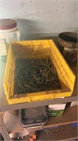 Shelf lot of screws and yellow containers