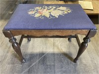 Vintage footstool with needlepoint fabric.