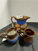 Copper luster pitcher and two small pitcher
