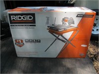 RIGID 7 INCH TILE WET SAW NEW IN BOX. W STAND