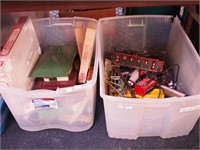 Two containers of model railroad cars, engines,