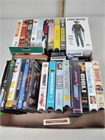 VHS tapes including Titanic and Hoosiers, DVDs