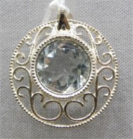 Sterling Silver with light blue stone pendant.