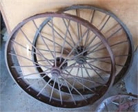 (2) Antique steel wheels. Measures 48" diameter.