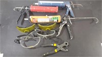 Lot of caulking guns, safety glasses