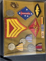 Shadow box of Marine patches and medals